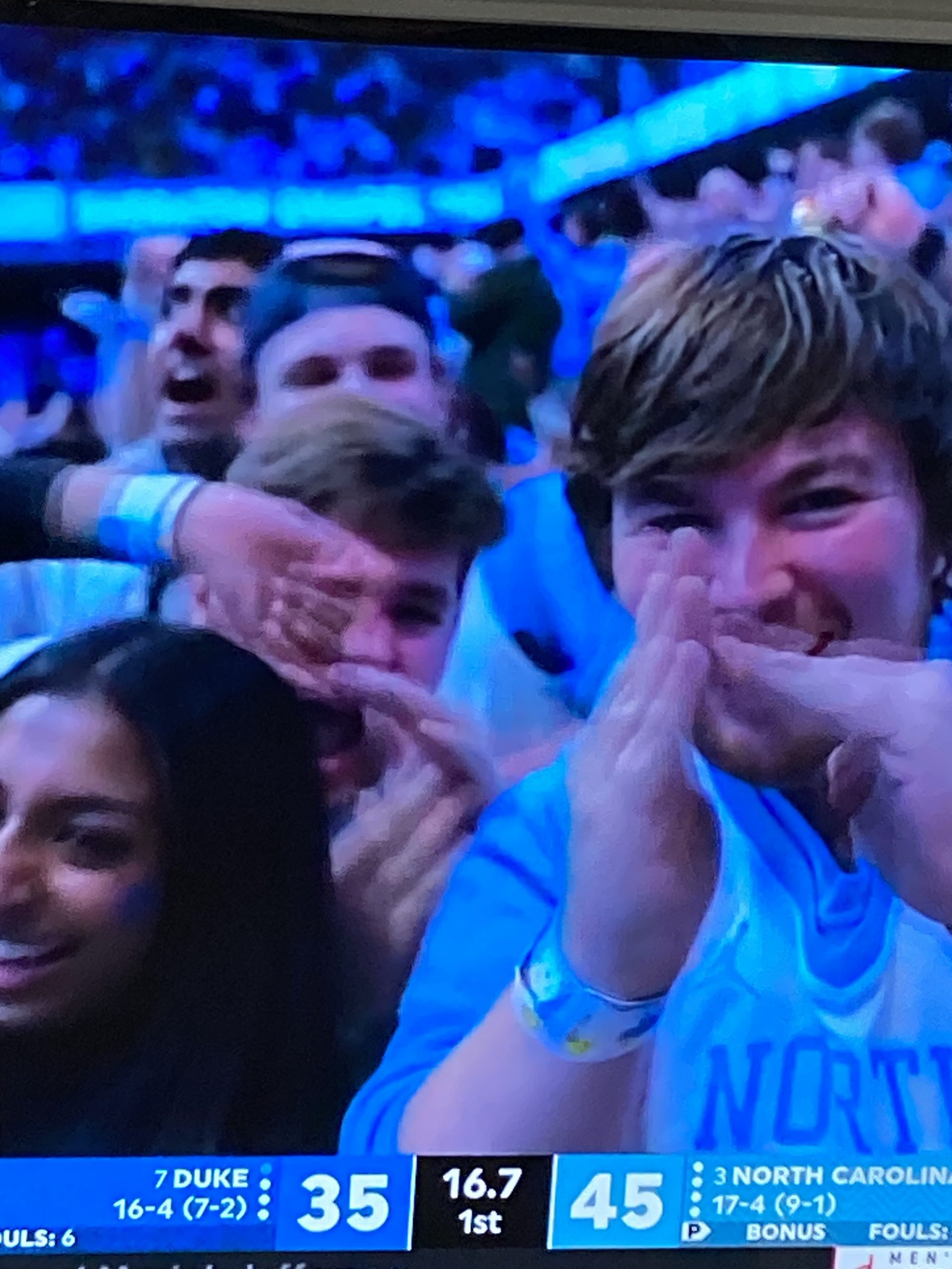 Jubilant UNC fans form the timeout symbol as Duke falls behind double digits late in the first half against UNC.